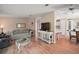 Bright living room features hardwood floors and modern decor throughout the home at 5300 Tigers Tail, Leesburg, FL 34748