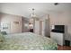 Spacious main bedroom features a chandelier and en suite bathroom at 5300 Tigers Tail, Leesburg, FL 34748