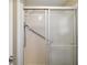 Updated shower with glass doors, safety handles, and shower wand at 5300 Tigers Tail, Leesburg, FL 34748