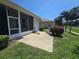 View of the back patio with seating and tropical landscaping at 5300 Treasure View Way, Leesburg, FL 34748