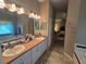 Bright bathroom with double sinks, vanity, and relaxing soaking tub at 5300 Treasure View Way, Leesburg, FL 34748