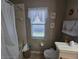 Cozy bathroom featuring a shower/tub combo and a window that provides natural light at 5300 Treasure View Way, Leesburg, FL 34748