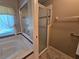 Bathroom featuring a soaking tub with shower and a separate glass door shower at 5300 Treasure View Way, Leesburg, FL 34748