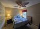 A bedroom featuring a ceiling fan, natural light, and traditional decor at 5300 Treasure View Way, Leesburg, FL 34748