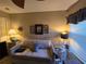 Bedroom featuring a sofa, desk, and glass-topped side table at 5300 Treasure View Way, Leesburg, FL 34748