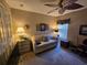 Bedroom with ceiling fan, sofa, and desk at 5300 Treasure View Way, Leesburg, FL 34748