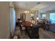 Open-concept dining room featuring wood table set near living area at 5300 Treasure View Way, Leesburg, FL 34748