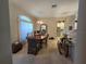 Open-concept dining room with wooden table set and a view of the living area at 5300 Treasure View Way, Leesburg, FL 34748