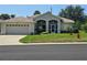 Beautiful one-story home featuring a manicured lawn and spacious two-car garage at 5300 Treasure View Way, Leesburg, FL 34748