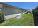 Exterior view of the property's backyard featuring a generator and air conditioning units at 5300 Treasure View Way, Leesburg, FL 34748