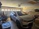 Organized garage with a parked car, shelving, and storage, providing ample space at 5300 Treasure View Way, Leesburg, FL 34748