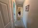 Neutral hallway with carpet, doors, and a glimpse into other rooms offering an open floor plan at 5300 Treasure View Way, Leesburg, FL 34748