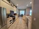 A spacious kitchen featuring stainless steel appliances and neutral-toned cabinetry, connecting seamlessly to the dining area at 5300 Treasure View Way, Leesburg, FL 34748