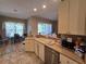 Beige cabinets and countertops in this kitchen space, offering views into the dinette and beyond at 5300 Treasure View Way, Leesburg, FL 34748