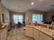 Kitchen area offering a cozy breakfast nook with natural light, complemented by sleek countertops and ample cabinet space at 5300 Treasure View Way, Leesburg, FL 34748