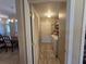 A practical laundry room with a washer, dryer, and storage shelves, located off the main hall at 5300 Treasure View Way, Leesburg, FL 34748