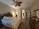 Spacious main bedroom featuring a large ceiling fan and views toward the ensuite bath and walk in closets at 5300 Treasure View Way, Leesburg, FL 34748