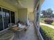 Relaxing screened patio with outdoor seating offering views of the beautiful surroundings at 5300 Treasure View Way, Leesburg, FL 34748