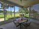 Screened patio with a table set and scenic views of the well-maintained community at 5300 Treasure View Way, Leesburg, FL 34748
