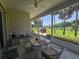 Screened patio area with a table and chairs offering serene outdoor living at 5300 Treasure View Way, Leesburg, FL 34748