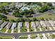 Aerial view of a neighborhood with community pool, tennis courts, and clubhouse at 5324 Treasure View Way, Leesburg, FL 34748