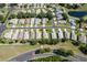 Aerial view of a neighborhood with homes along winding streets, and a pond at 5324 Treasure View Way, Leesburg, FL 34748