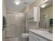 Neutral bathroom with a shower, toilet, vanity, and tile floors at 5324 Treasure View Way, Leesburg, FL 34748