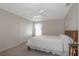 Bright bedroom with a ceiling fan, carpet, and a full bed beneath a window at 5324 Treasure View Way, Leesburg, FL 34748