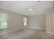 Spacious bedroom with carpeted floors and natural light from two large windows at 5324 Treasure View Way, Leesburg, FL 34748