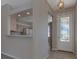 Inviting foyer with tile flooring and an open view into the kitchen at 5324 Treasure View Way, Leesburg, FL 34748
