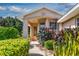 Inviting front entrance with a covered porch and attractive landscaping at 5324 Treasure View Way, Leesburg, FL 34748