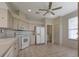 Spacious kitchen featuring white appliances and ample cabinet space at 5324 Treasure View Way, Leesburg, FL 34748