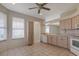 Bright eat-in kitchen featuring tile flooring, and ample cabinet space at 5324 Treasure View Way, Leesburg, FL 34748