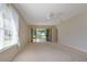Large living room with sliding glass doors and neutral carpeting at 5324 Treasure View Way, Leesburg, FL 34748