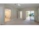 Spacious primary bedroom featuring neutral carpet, and access to the lanai at 5324 Treasure View Way, Leesburg, FL 34748