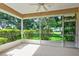 Screened patio with a view of the landscaped yard and mature trees at 5324 Treasure View Way, Leesburg, FL 34748