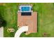 Aerial view showcasing the home's roof, solar panels, screened pool, and manicured landscaping at 5400 Saddleback Ct, Lady Lake, FL 32159