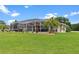 A spacious screened-in patio and meticulously manicured backyard, perfect for relaxation and entertainment at 5400 Saddleback Ct, Lady Lake, FL 32159