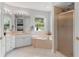 Bright bathroom features a large tub and a glass-enclosed shower at 5400 Saddleback Ct, Lady Lake, FL 32159