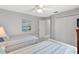 Light and airy bedroom with twin beds, white closets, and a soothing, neutral color palette at 5400 Saddleback Ct, Lady Lake, FL 32159