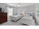 Bright bedroom featuring two twin beds, soft carpet, and a ceiling fan for added comfort at 5400 Saddleback Ct, Lady Lake, FL 32159