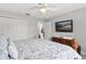Bright bedroom features a queen bed and a closet for storage at 5400 Saddleback Ct, Lady Lake, FL 32159