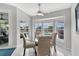 Bright dining area has a ceiling fan and a bay window looking out to the pool at 5400 Saddleback Ct, Lady Lake, FL 32159