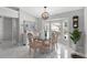 Elegant dining room with stylish table setting and large windows offering ample natural light at 5400 Saddleback Ct, Lady Lake, FL 32159