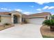 Beautiful home exterior with manicured landscaping, elegant design elements, and an attached garage at 5400 Saddleback Ct, Lady Lake, FL 32159
