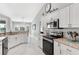 Modern kitchen featuring sleek appliances, granite countertops, and a functional layout for cooking at 5400 Saddleback Ct, Lady Lake, FL 32159
