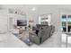 An airy living room featuring comfortable seating, natural light, and serene views of the pool area at 5400 Saddleback Ct, Lady Lake, FL 32159