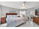 Bright main bedroom features a ceiling fan, a queen bed and an exit to the patio at 5400 Saddleback Ct, Lady Lake, FL 32159