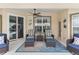 Inviting covered patio with comfortable seating, stylish decor, and a relaxing outdoor ambiance at 5400 Saddleback Ct, Lady Lake, FL 32159