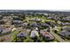 Beautiful aerial view of a lakeside community with lush landscaping, mature trees and roundabout at 5604 Gulf Stream St, Tavares, FL 32778